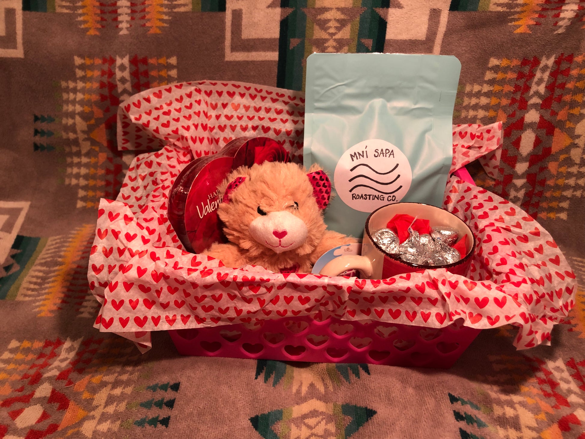Pictured: basket with coffee, mug, chocolates and a plush animal